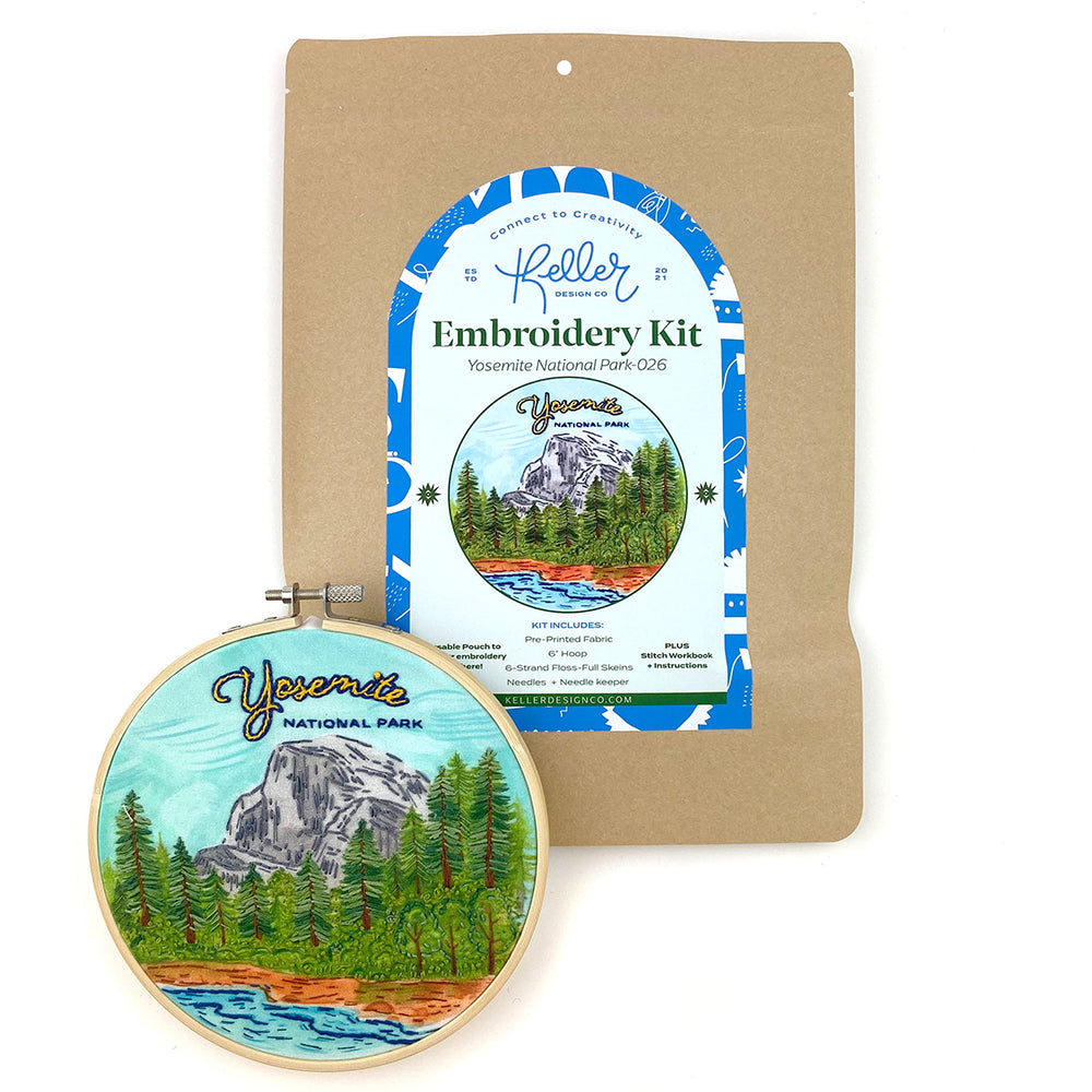 Yosemite National Park Embroidery kit in a hoop. Finished Embroidery sits on top of an illustration of Yosemite.